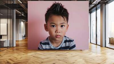 portrait of cute little asian boy with messy hair on pink background Wall mural