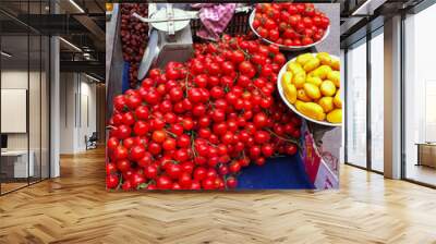 Cherry tomatoes, strawberries, and dried fruit for sale on a street cart in China Wall mural