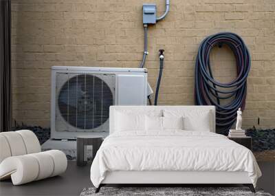 Air Conditioner mini split system next to home with brick wall Wall mural