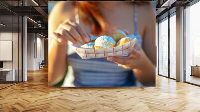 young woman eating fried oreos Wall mural