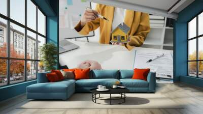 Sales staff discuss home details with customers before agreeing to sign a sales contract, buying and selling real estate, making recommendations and offerings, drafting home sales contracts. Wall mural