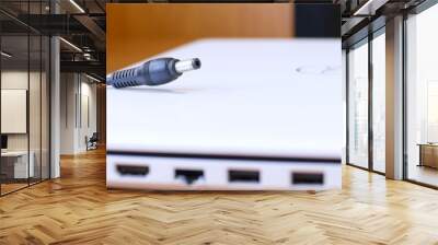 the plug  power adaptor to recharge the notebook. The concept of electronic device for use everyday   Wall mural