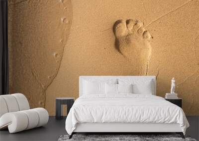 Footsteps in sandy on the beach Wall mural