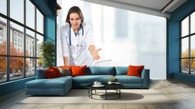 Group of young doctors working together on modern clinic background. Wall mural