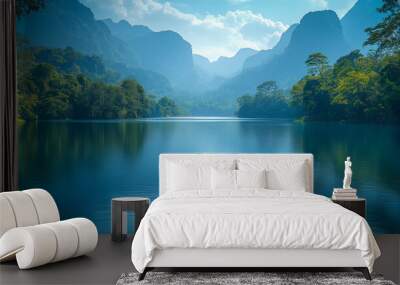 A peaceful river view, the calm water reflects the surrounding mountains and trees, with a lush jungle lining the riverbank. Wall mural