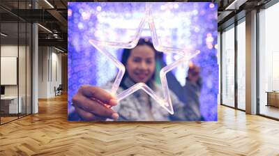   happy feeling .woman showing LED star symbol .bokeh dot light blure   Wall mural