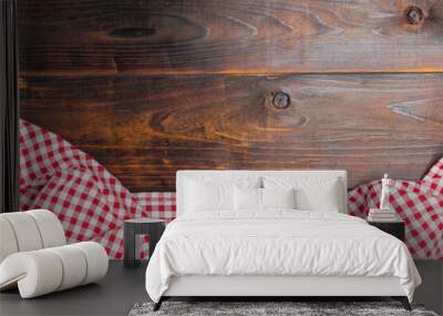 Fabric red and white cover on the table. Flat lay, top view. Background of menu for the restaurant, copy space. Checkered red and white tablecloth on an old wooden brown background with copy space. Wall mural