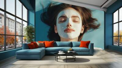 Revitalize your skin with rejuvenating mask, as woman relaxes on serene backdrop, embodying tranquility and self care Wall mural