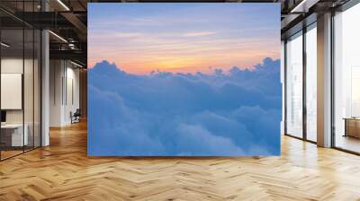 beautiful yellow sunlight of sun while sunrise or sunset with soft blue cloud above peak mountain Wall mural