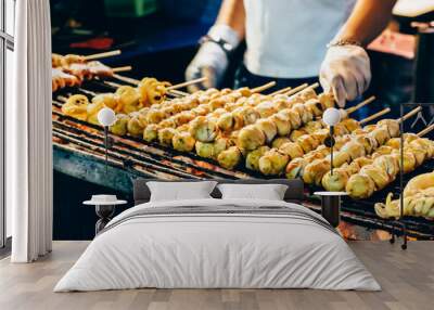 Closeup of grill squid on stick for sale. Thai street food vendor in Bangkok, Thailand. Wall mural