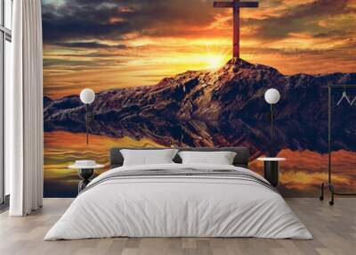 Water reflection of cross silhouette at sunset sky background. Wall mural