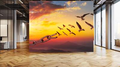 World freedom day concept, bird flying and broken chains at sky sunset background Wall mural