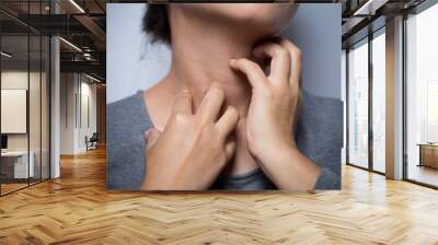 Woman scratching her neck Wall mural