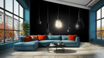 Glowing light bulb is hanging between a lot of turned off light bulbs on dark black background, copyspace, transparent vector Wall mural