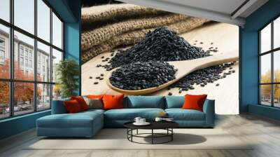 Close up black sesame in wooden spoon Wall mural