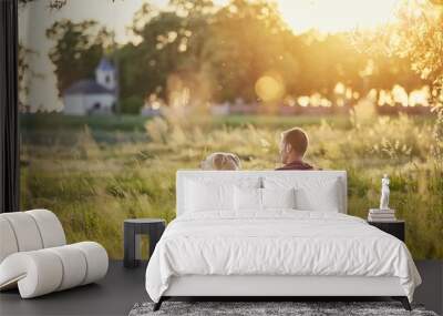 Man with his dog at sunset Wall mural