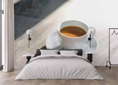 Coffee in white cup on the floor in the morning .  Wall mural