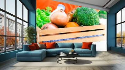 Delivering fresh fruits and vegetables to your doorstep eating non-toxic fruits and vegetables.Organic vegetables, broccoli,fresh milk,lettuce are arranged in a wooden tray.Banner cover design. Wall mural