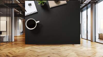 desk office top view with blank notepad, pen, coffee and plant on black background. flat lay with copy space. Wall mural