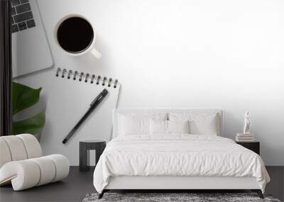 Flat lay, top view office table white desk. Workspace with notepad, pen, green leaf, and coffee cup on white background. Wall mural