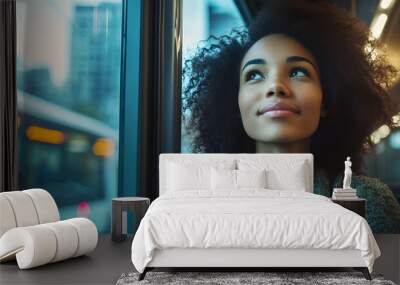 A woman with curly hair is looking out the window of a bus Wall mural