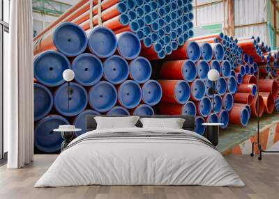 Red steel pipes for fire fighting system and extinguishing water lines in industrial building. Paint shop. Steel pipe of round industrial Steel Pipes bunch on a construction site Wall mural