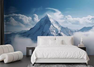 Magnificent snow-capped peak above the clouds with a blue sky Wall mural