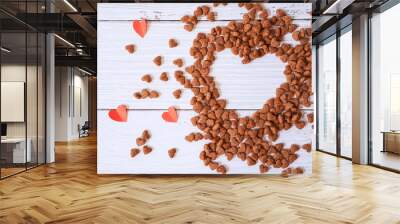 Top view of heart shape space made from heart shape dog food and red paper heart on white wooden background for Valentine , love and dog lover concept Wall mural