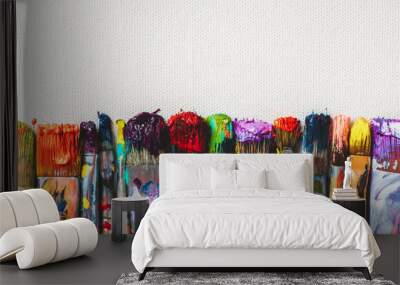 row of artist paintbrushes closeup on artistic canvas. Wall mural