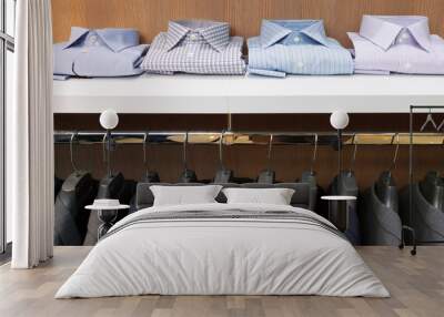 row of men suit jackets on hangers and shelf with shirt in cloth Wall mural