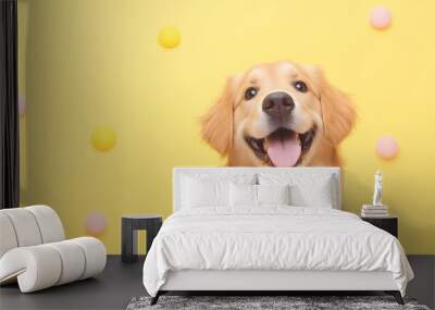 A cheerful golden retriever dog with a bright smile, standing against a vibrant yellow background adorned with colorful pastel balls. Wall mural