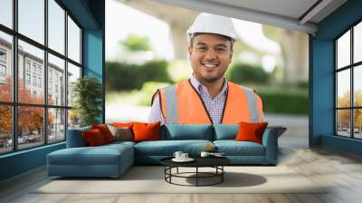 Asian civil engineer operate with tablet to control working at construction. Worker wearing hard hat at highway concrete road site. Wall mural