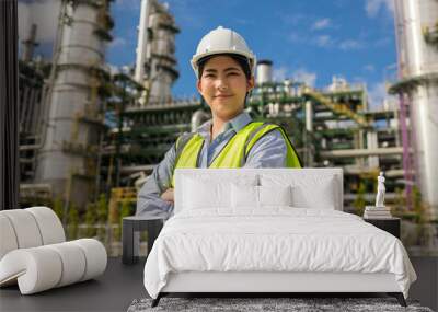 asian engineer manager woman with white safety helmet standing front of oil refinery. industry zone  Wall mural