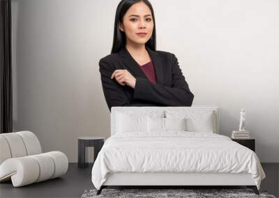 Attractive Young asian business woman smiling to camera standing pose on isolated white background. Latin Female around 25 in black suit portrait shot in studio. Wall mural