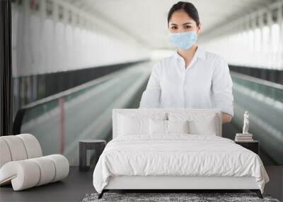 Business woman wearing protection mask. Beautiful female protective virus and pollution with face mask. Wall mural