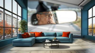 Rear view mirror. Senior asian man driver was drowsy. Mature old man yawned and was about to fall asleep Doze off Driving for a long time sleep deprivation Wall mural