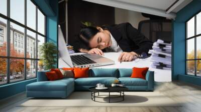 The business woman worked so hard that she fell asleep at her desk. Working overtime because it's almost time for the deadline. She was tired from job and took a nap. Wall mural