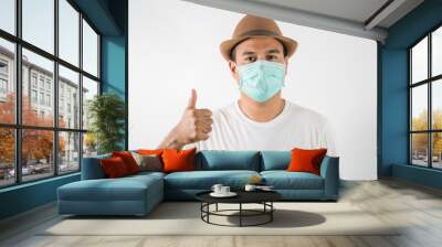 The young man had a cold and a fever. He wearing  protection mask. coronavirus or covid 19 concept. Wall mural