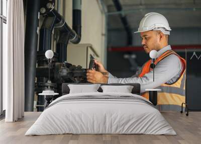 young asian engineer working at valve water pump checking and maintenance for the safety. worker con Wall mural