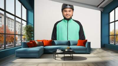 Young asian rider wearing green jacket uniform and bike helmet standing various action on isolated white background. Male delivery service worker. Delivery courier and shipping food service. Wall mural