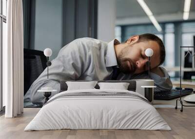 A man sleeping on the table with a coffee mug in the modern workplace setting Wall mural