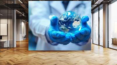 Doctor's hand holding the earth in his hands. Wall mural