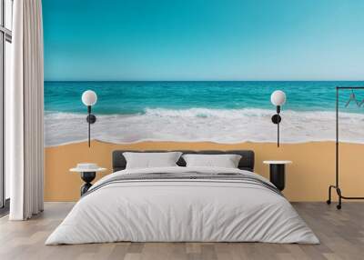 Scenic beach view with turquoise ocean and soft sand under clear blue sky. Wall mural