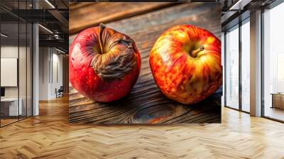 contrast, food, A high angle stock photo showcasing a comparison between a fresh vibrant red apple and a decayed rotten one illuminated with warm sunlight resulting in a bokeh effect Wall mural