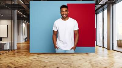 Potrait of a model in white tshirt with blue background  Wall mural