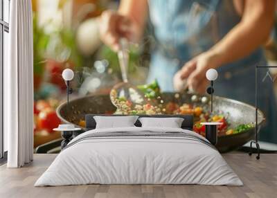 Woman preparing quinoa vegetable mix cooked in a frying pan  Wall mural