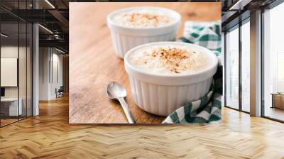 Arroz con leche. Rice pudding with cinnamon on wooden background
 Wall mural