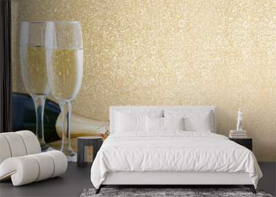 Champagne bottle with glass cups on brilliant golden background

 Wall mural