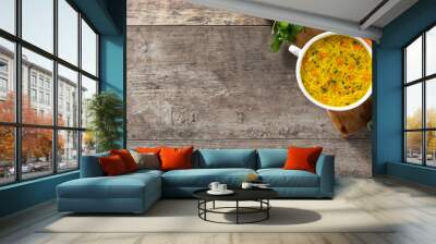 Chicken noodle soup in white bowl on wooden table.Top view. Copy space Wall mural