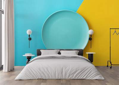 Empty blue plate on yellow and blue background.Copy space Wall mural